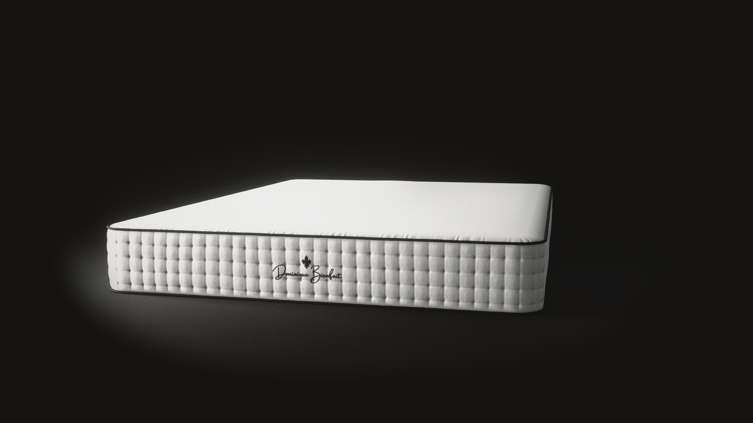 A white mattress on a black floor, lit from the left: its tufted foot end with a black fleur-de-lis and the name Dominique Bienfait, its long tufted sides and black piping.