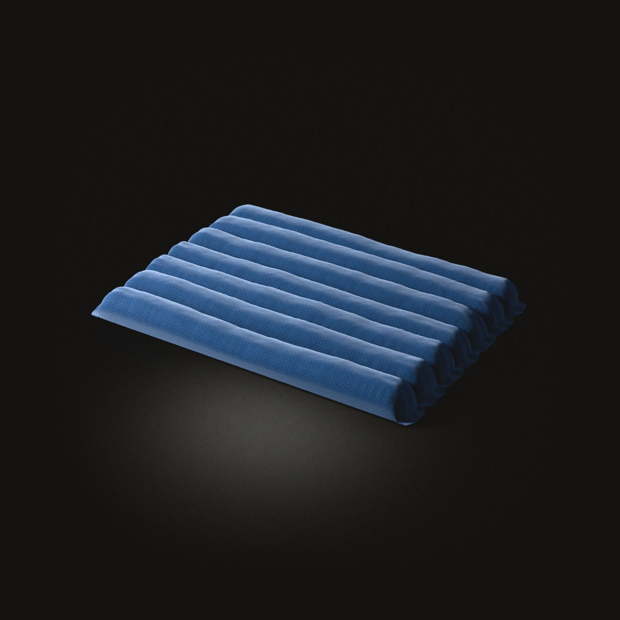 Un tapis de méditation bleu sur un sol noir : sept boudins bien rembourrés côte à côte, piqués entre eux et fermés aux extrémités.